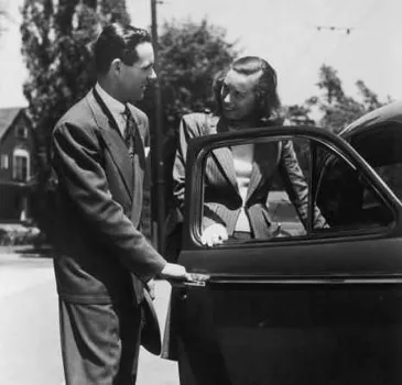 Man-holding-car-door-open